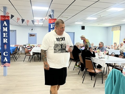 Person walking back to table at the Patriot Luncheon