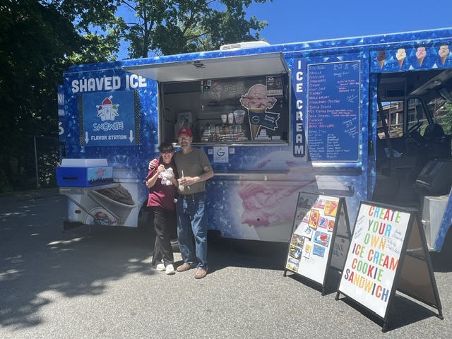 Worker smiling inside the ice cream truck