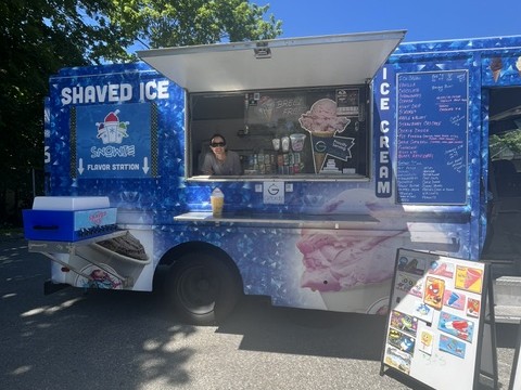 Couple posing in front of the ice cream truck