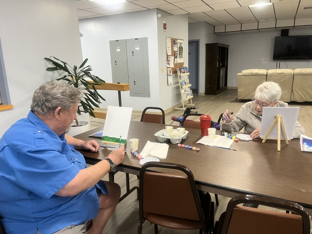 Two seniors painting